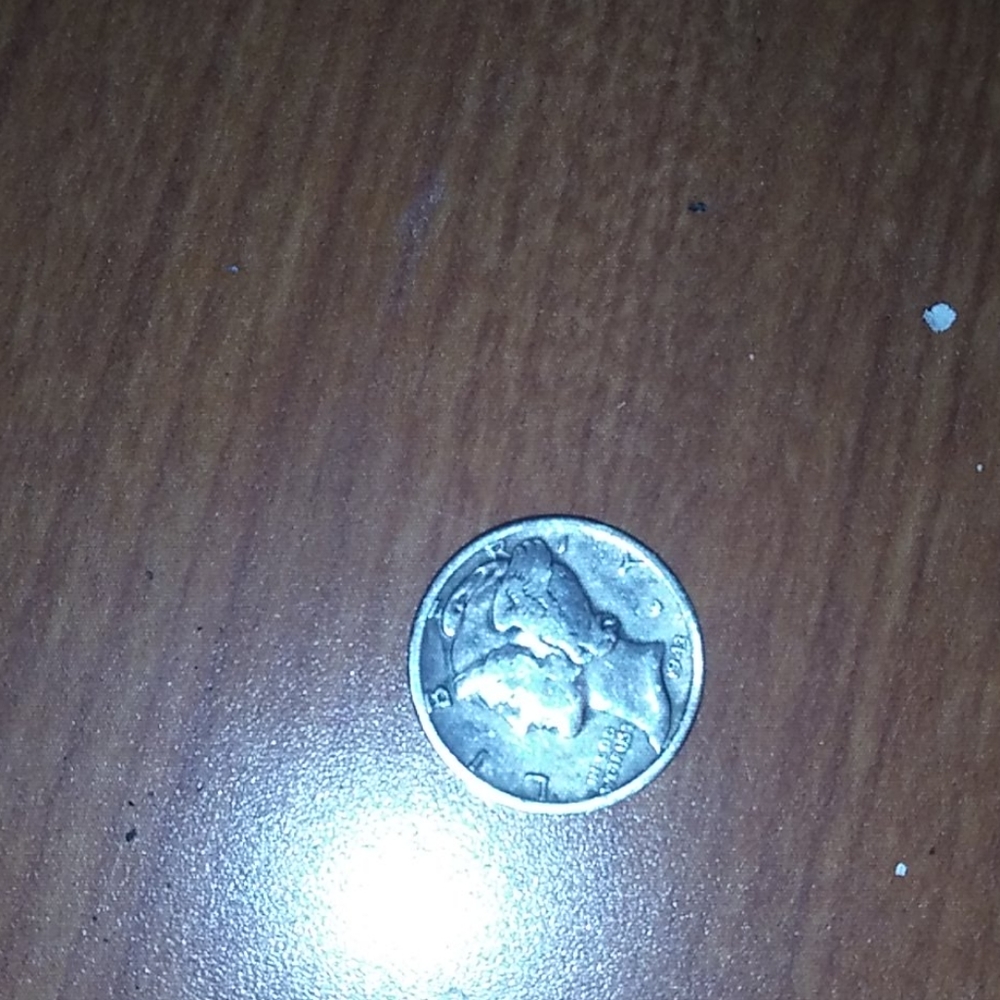 A 1943 silver dime with a lady on it.